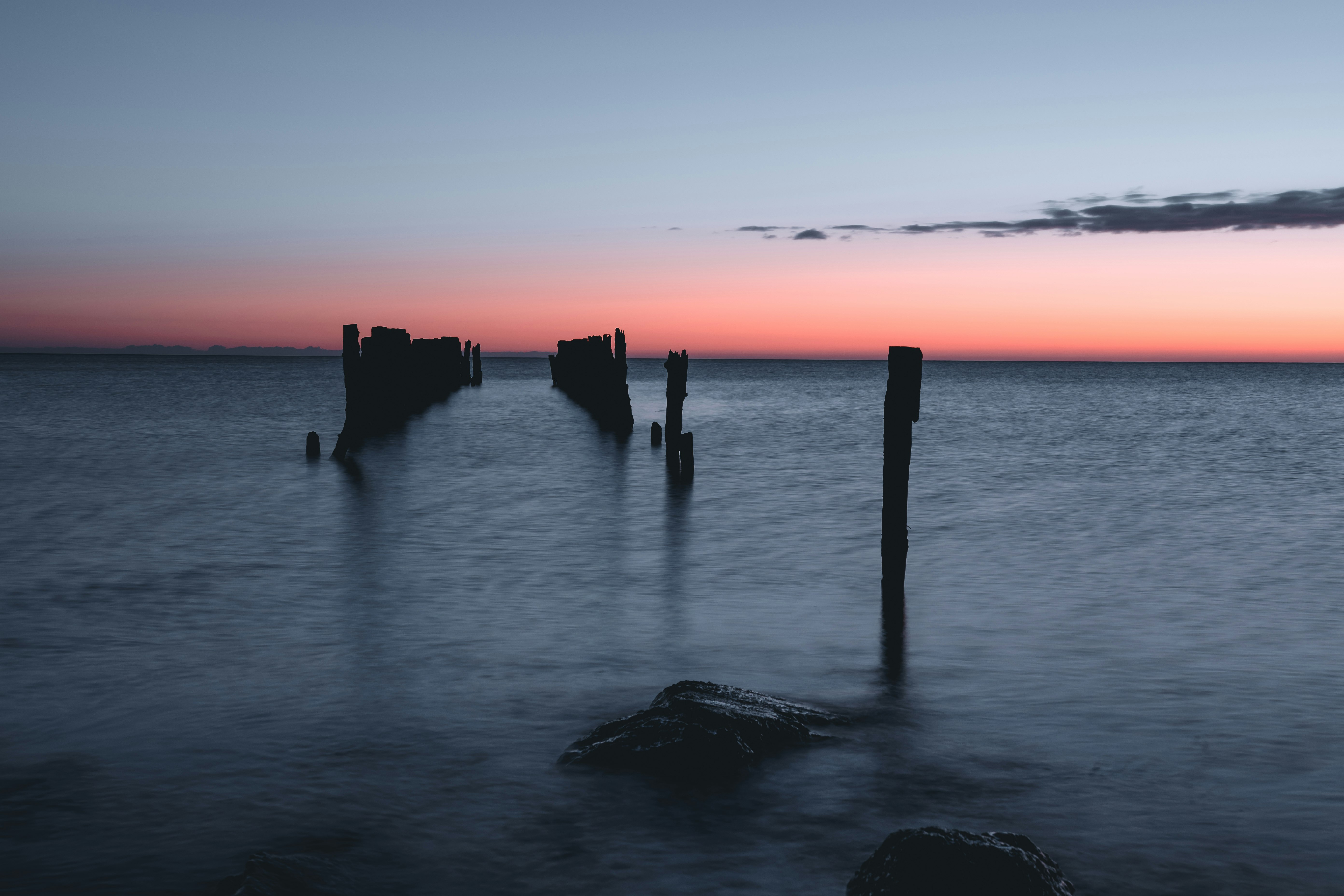 silhouette of people on sea during sunset